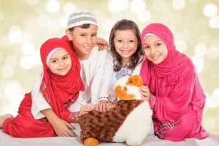 Happy little Muslim family celebrating Eid ul Adha