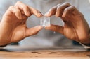Hands of man holding melting ice cube
