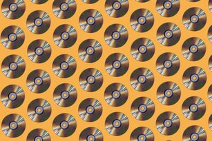 Silver compact discs pattern on yellow background. Music, storage, dating and retro vintage concept.