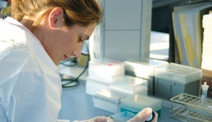 Lab assistant working with a ZEISS microscope