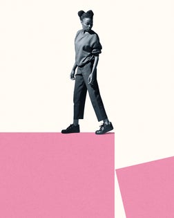 Young woman walking while looking back at block