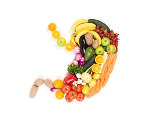 Stomach made out of fruits and vegetables isolated on white background