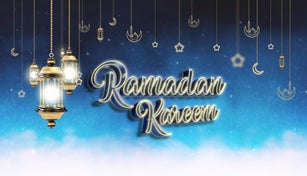 Traditional Ramadan candles, decoration and lit Ramadan Kareem text on the night background