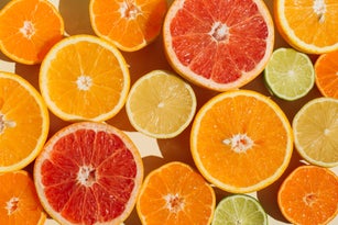 Pattern of slices citrus-fruit of Lemons, oranges, grapefruit, lime on beige background. Healthy food, diet and detox concept. Flat lay, top view