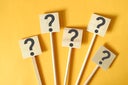Question mark symbol on wooden sign