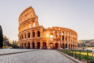 Sunrise seen through the arches of Coliseum in the morning, Rome, Italy