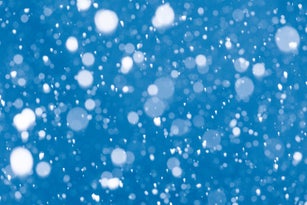 Abstract blue bokeh background with falling snow effect