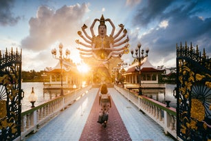 Asian woman visiting Wat Plai Laem, Ko Samui, Thailand