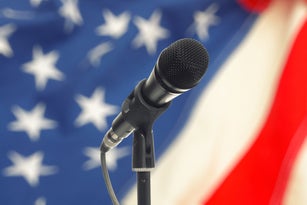 Microphone on stand with USA flag on background