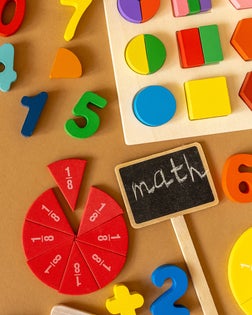 Wooden kids toys on colourful paper. Educational toys blocks, pencils. Toys for kindergarten, preschool or daycare. Back to school. Copy space for text.