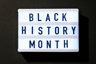 Lightbox with text BLACK HISTORY MONTH on dark black background. Message historical event