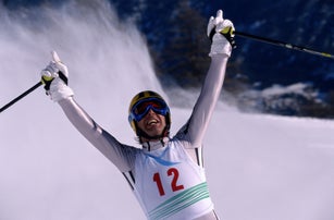 Skier raising hands in victory