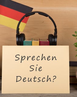 paper with text "sprechen sie deutsch?", flag of the Germany