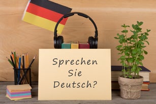 paper with text "sprechen sie deutsch?", flag of the Germany