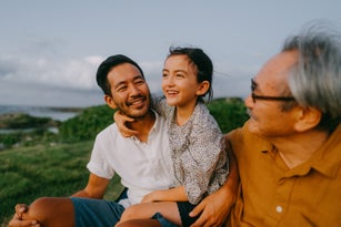 Three generation family having a good time at dusk