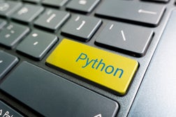 button with the python on the yellow keyboard of modern laptop.
