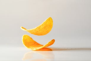 fried Potato chips jump in mid air captured with high speed sync.