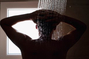 Close-up of a young man in the shower
