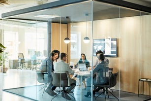 Business Colleagues Discussing Strategy At Office