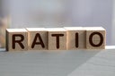 Block of alphabet letters forming the word RATIO on wooden surface. Concept of common marketing business terms. Slightly defocused and close-up shot. Copy space.