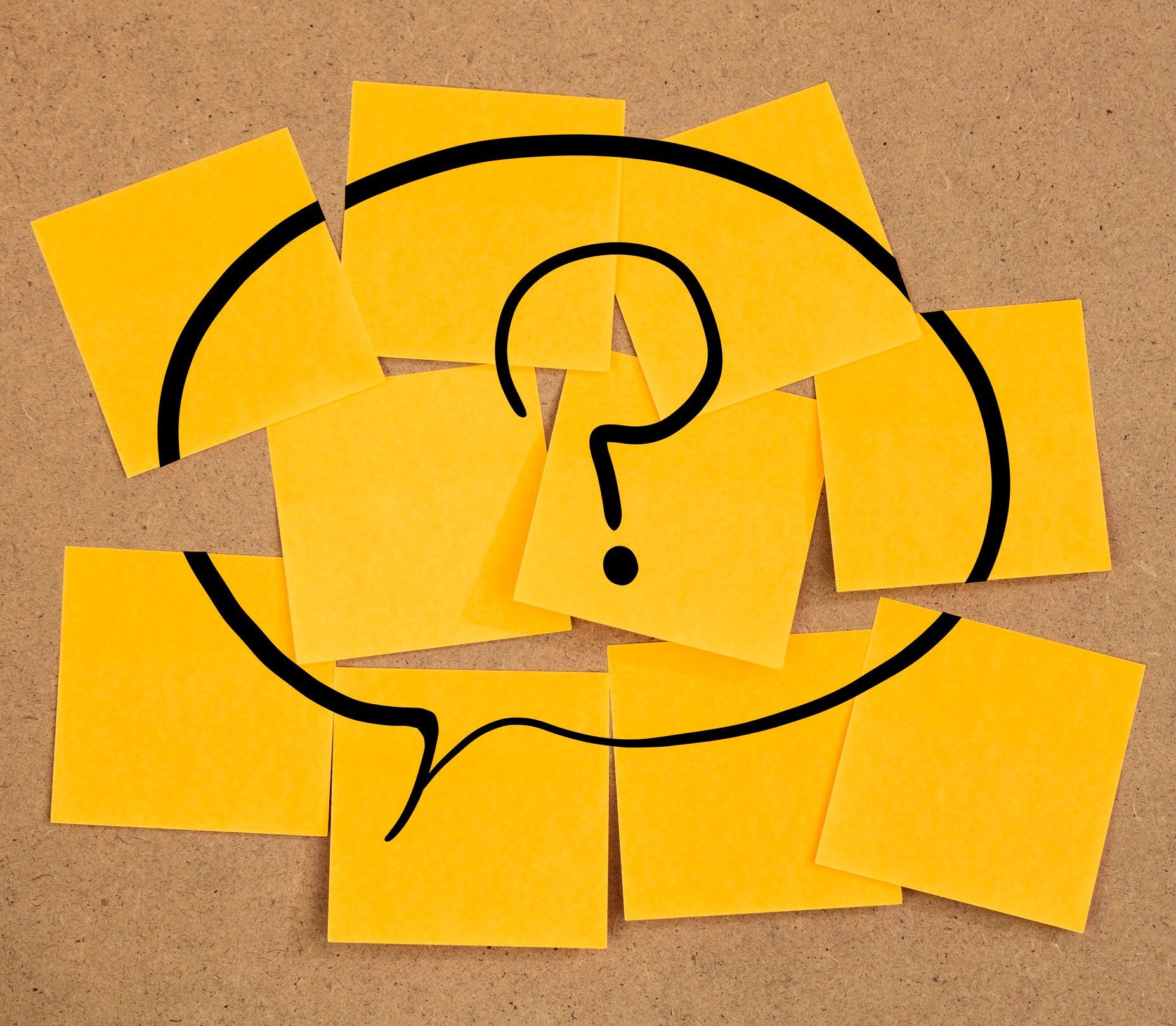 speech bubble with question mark on sticky notes on a board