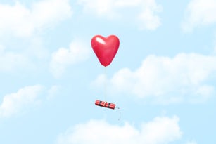 Heart shaped balloon carrying a dynamite stick