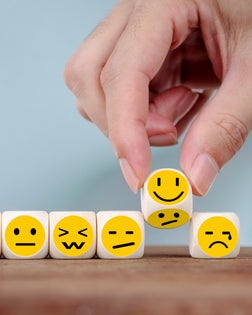 Hand Changing with smile emoticon icons  face on Wooden Cube , hand flipping unhappy turning to happy symbol