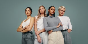 Group of fashionable women standing in a studio