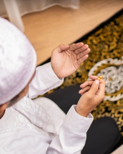 Muslim Man With Open Palm Praying and Dhikr at Home During Month of Ramadan