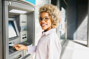 Woman using ATM
