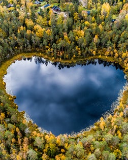 Heart-shaped lake surrounded by forest