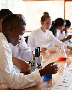 Student doing experiment with pipette & liquid