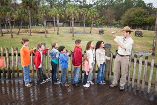 Zoo keeper with group of children