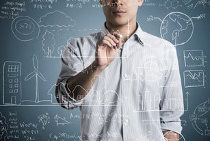 Man writting a formula and picture in chalk