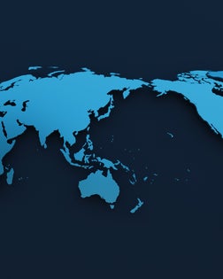 Light blue world map. Flat projection with copy space around the continents on a dark background.