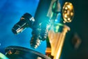 Old antique microscope closeup with lensflare. Selective focus.