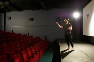 Actor rehearsing on stage.
