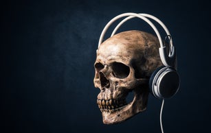 human skull listening with headphones