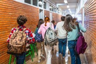 Students running in school hallway between classes