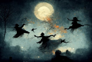 Witches flying in the night sky on Halloween during a full moon