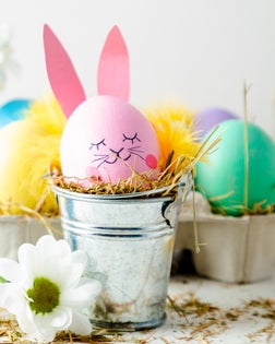 Close-Up Of Colorful Easter Eggs On Table Against White Background