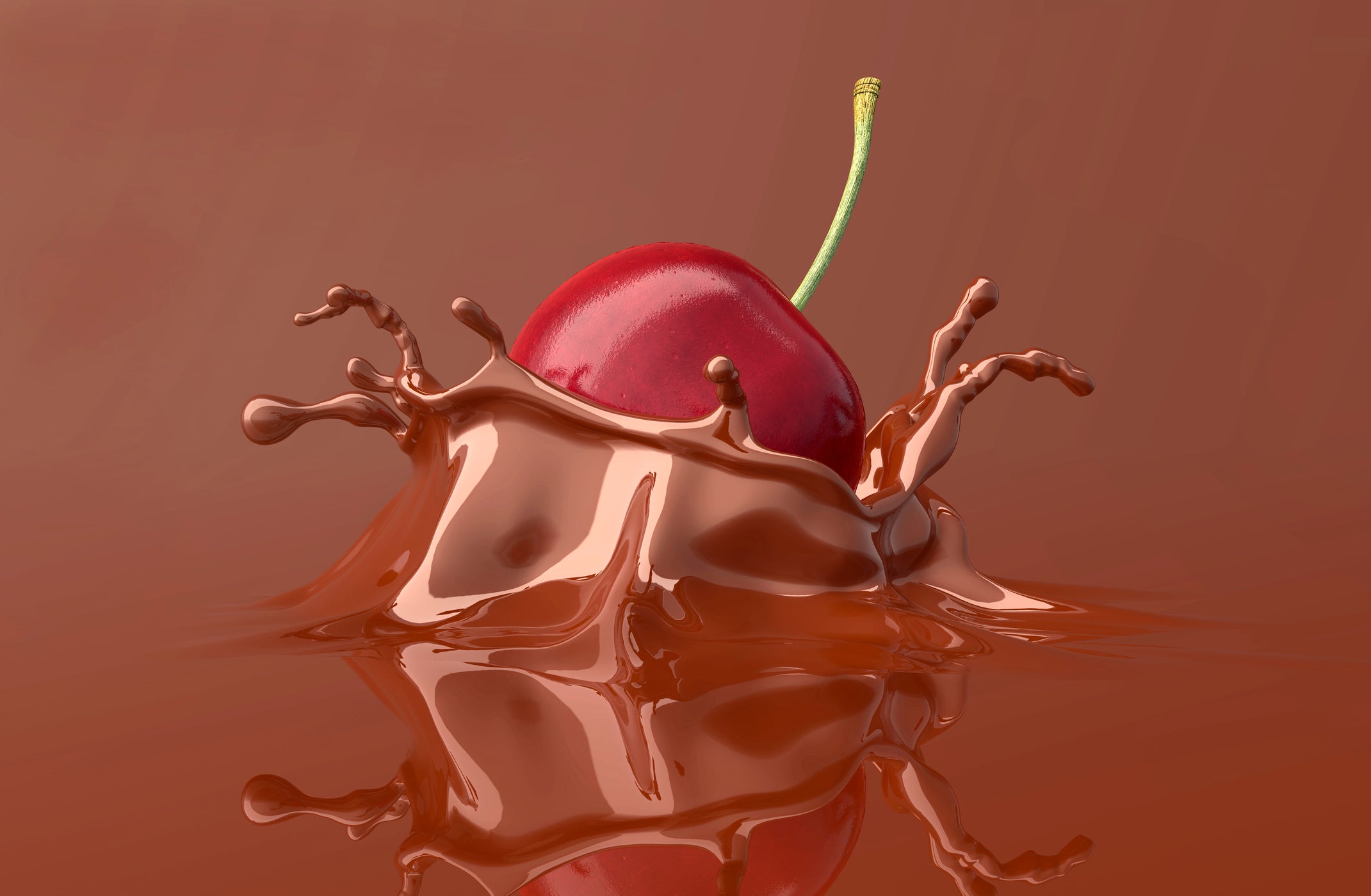 red cherry falling and splashing into chocolate.