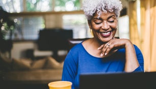 Cheerful woman on video call at home