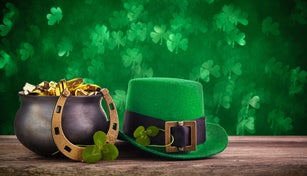 St Patrick's Day hat and pot with gold coins on green twinkling bokeh background