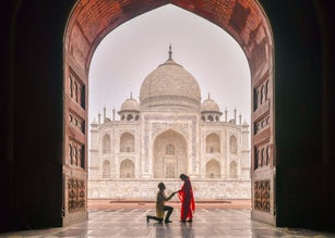 A man proposing woman with the view of Taj Mahal in Agra, India