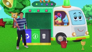 Josh is standing in front of three bins. Each bin is a different color. The blue bin is for paper, plastic, and metal. The green bin is for fruit and vegetable scraps. The black bin is for other kinds of trash. Josh is ready to sort his rubbish into the right bin.