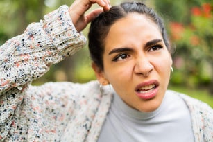 Young Latino woman making a face looking uncertain, confused, perplexed, WTF
