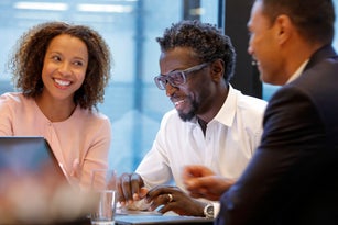 Business people interacting and laughing during a meeting