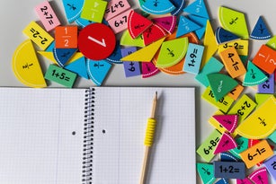 back to school background. colorful math fractions and notebook on the table. Mathematics and geometry in preschool and school