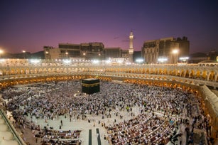 Muslim pilgrims circumambulate the Kaaba at dawn